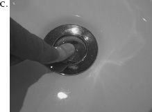 FIGURE 1.4. The Sink That Would Not Drain: Where Signifiers Fail. I washed my hands in my hotel sink in London, but then, as shown in Photo A, was left with the question of how to empty the sink of the dirty water. I searched all over for a control: none. I tried prying open the sink stopper with a spoon (Photo B): failure. I finally left my hotel room and went to the front desk to ask for instructions. (Yes, I actually did.) “Push down on the stopper,” I was told. Yes, it worked (Photos C and D). But how was anyone to ever discover this? And why should I have to put my clean hands back into the dirty water to empty the sink? The problem here is not just the lack of signifier, it is the faulty decision to produce a stopper that requires people to dirty their clean hands to use it. (Photographs by the author.)
