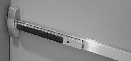 FIGURE 2.5. Panic Bars on Doors. People fleeing a fire would die if they encountered exit doors that opened inward, because they would keep trying to push them outward, and when that failed, they would push harder. The proper design, now required by law in many places, is to change the design of doors so that they open when pushed. Here is one example: an excellent design strategy for dealing with real behavior by the use of the proper affordances coupled with a graceful signifier, the black bar, which indicates where to push. (Photograph by author at the Ford Design Center, Northwestern University.)